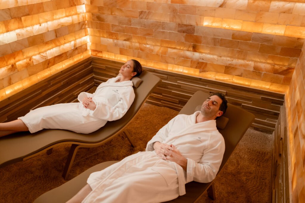 An image from the Healthians spa center of a man and a woman getting a spa service.